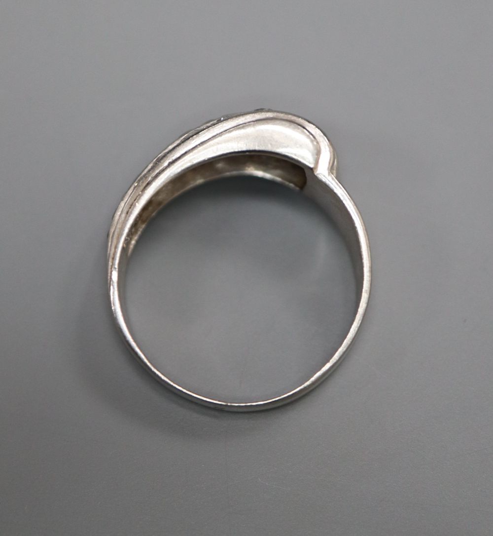 A stylish white metal (stamped Plat), graduated ruby and diamond set twin row dress ring, size O, gross 7.2 grams.